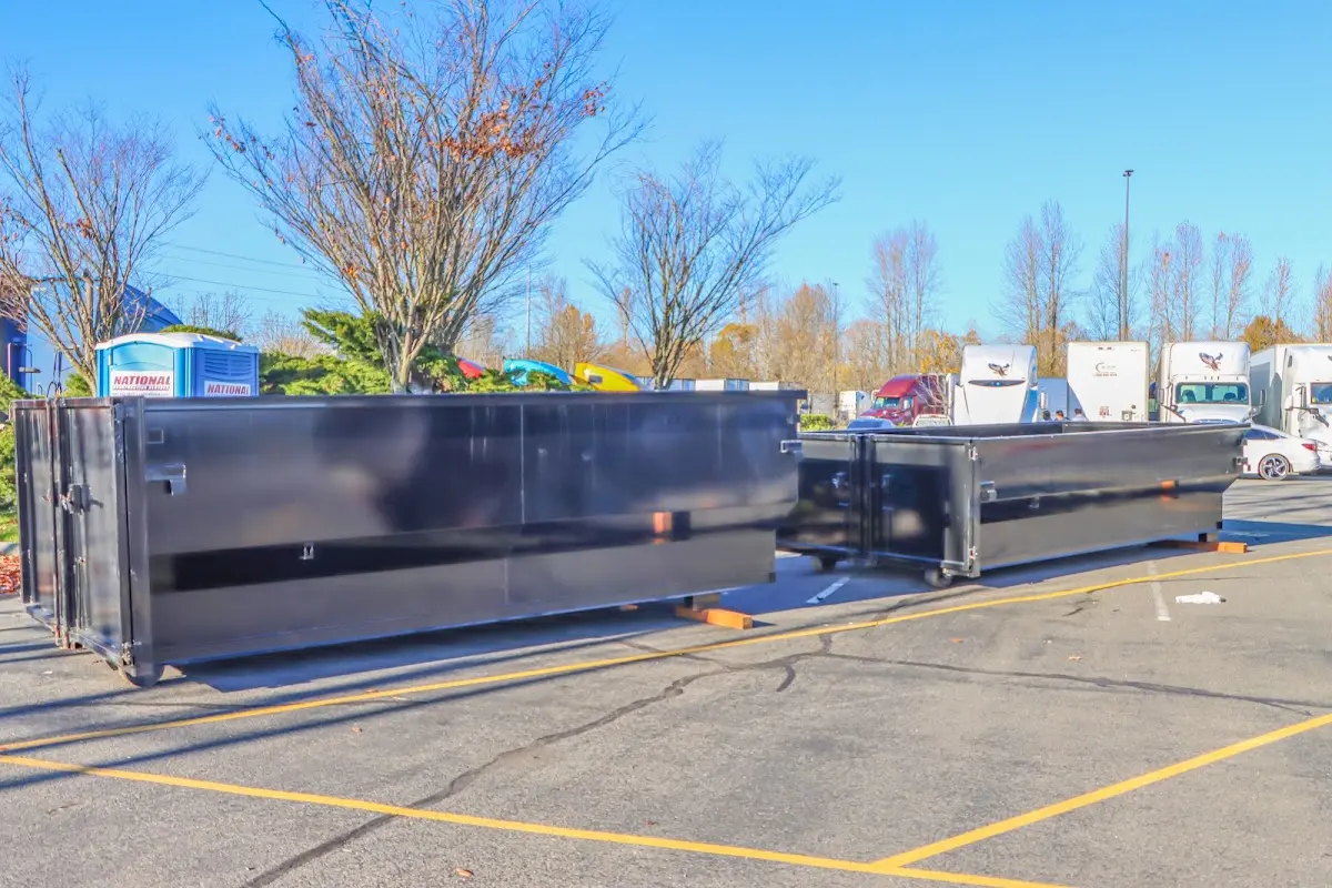 Professional dumpster rental service with roll-off container on residential driveway in Kenosha